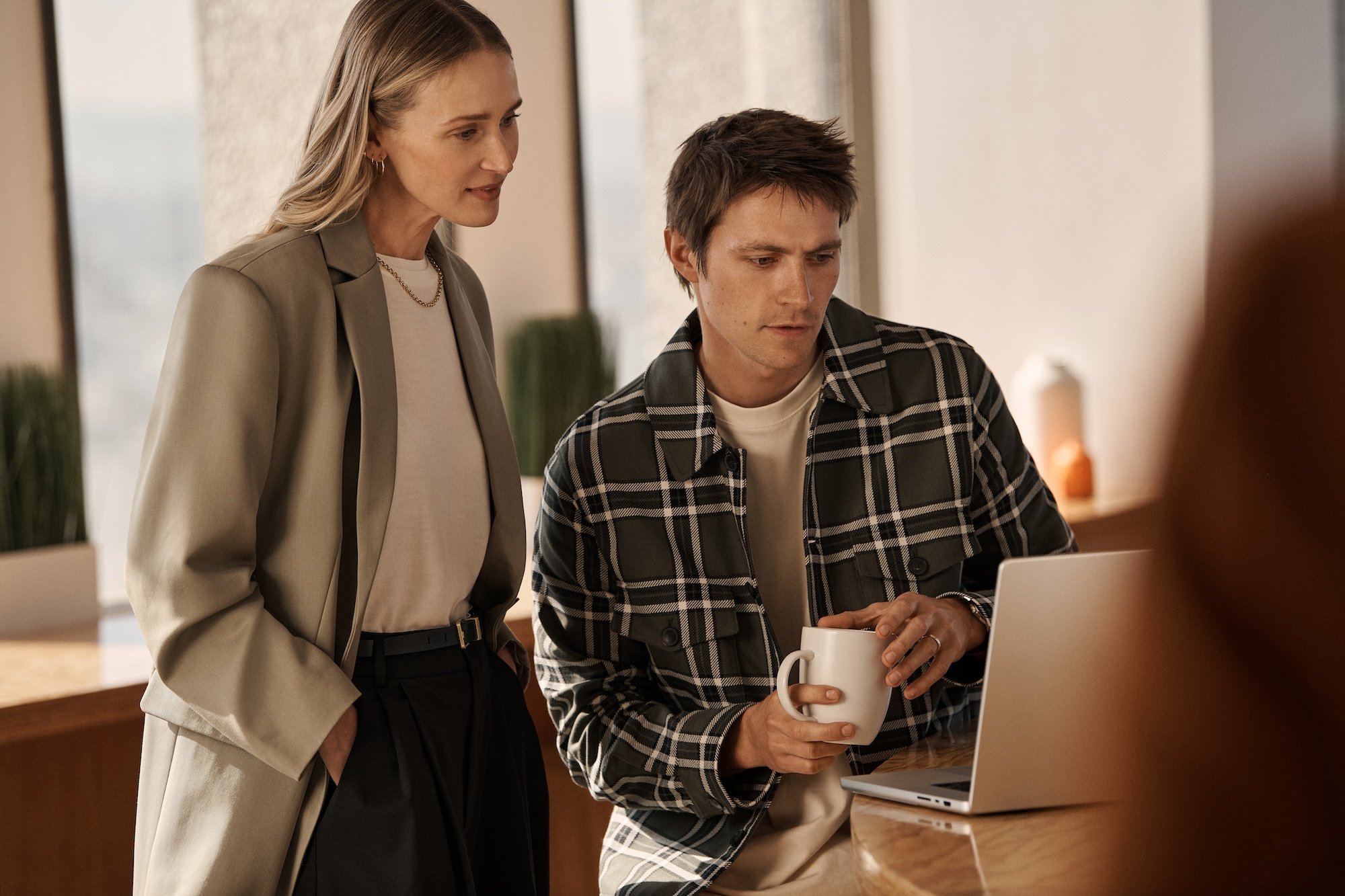 Two professionals looking at a laptop