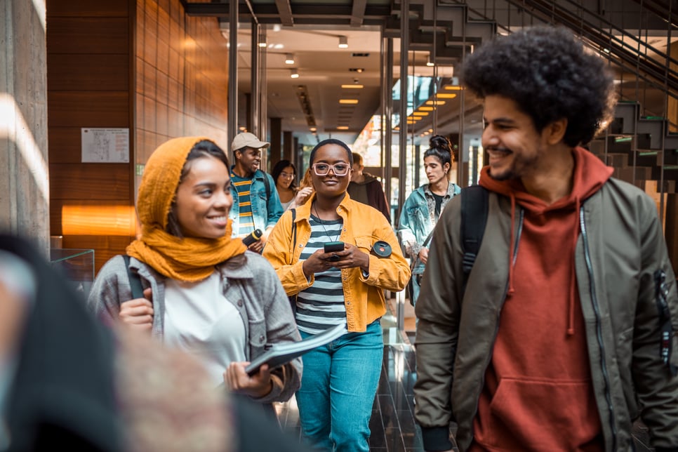 this photo shows a diverse group of Black individuals exiting a building