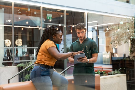 Two people looking at a tablet