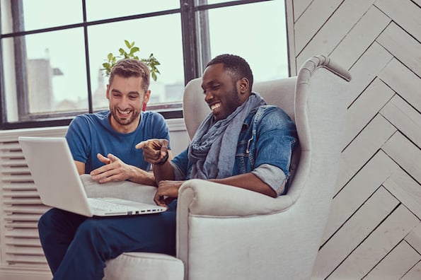 Two young students discussing how to speed up a website with image optimization