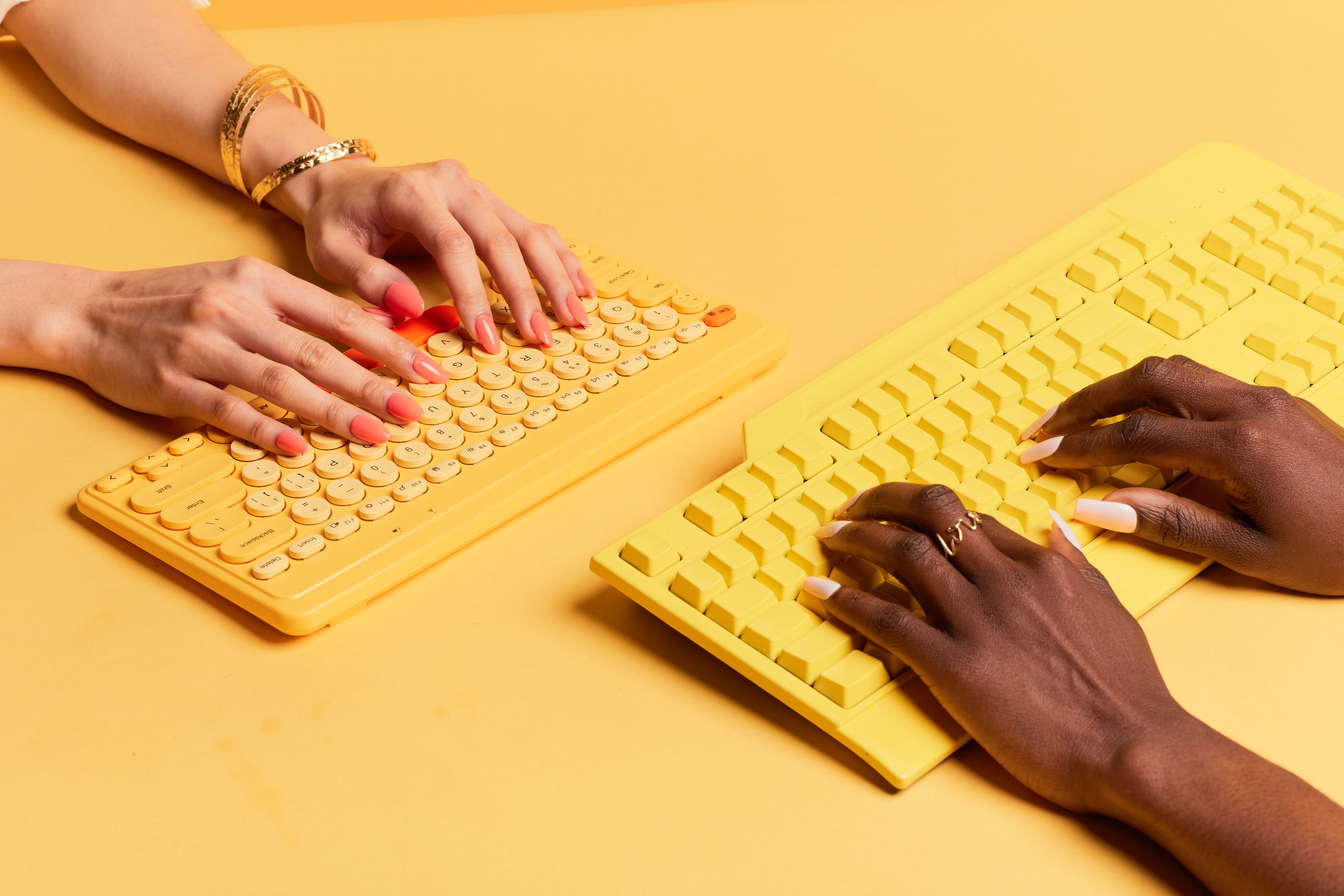 people typing on keyboard