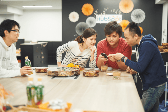 Work team looking at cellphone Tokyo Office
