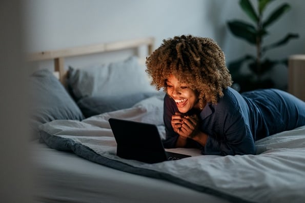 Young woman happily studying JavaScript array methods and how she can use them.