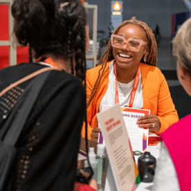 Lady smiling at attendee at INBOUND