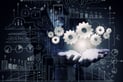 Close up of businesswoman holding gears in hand