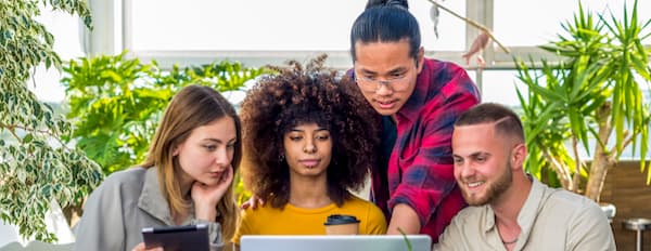 Team of marketers look at screen to work on content strategy