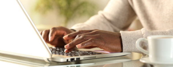 a marketer creates an email newsletter on a laptop