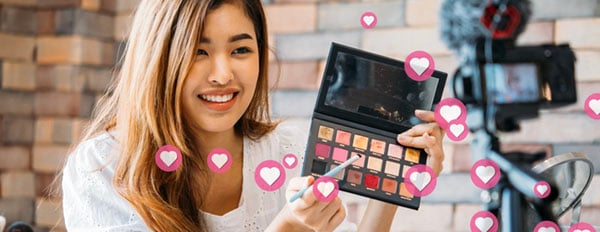 a social media marketer streams live on social media to show off her brands eye shadow palette-1