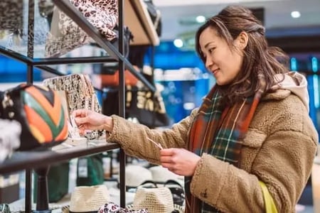 Woman shops and is delighted by the store's Black Friday marketing strategy. 