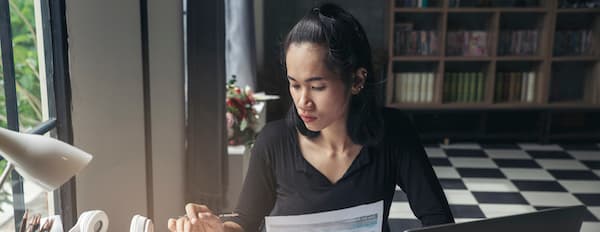 Entrepreneur sits at work desk to create a business budget