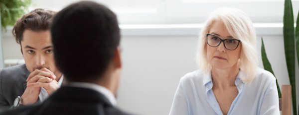 HR representatives sit across from employee to conduct exit interviews