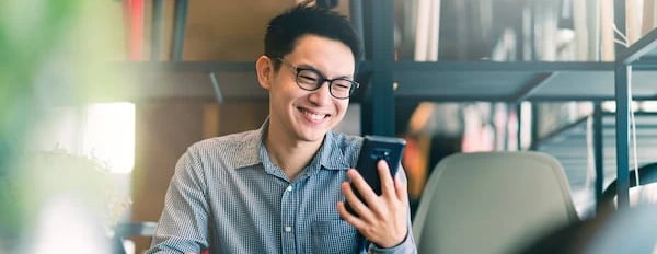 Social media user laughs at content on phone