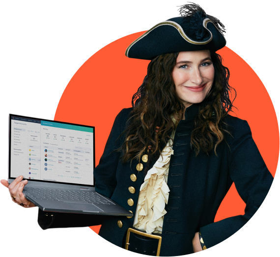 Kathryn Hahn, dressed as a pirate Captain, holding a laptop happily using HubSpot CRM.