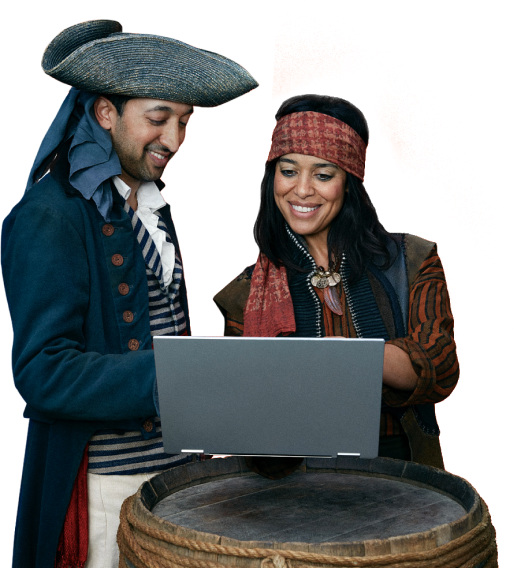 Two pirates smiling, looking at a laptop happily using HubSpot CRM