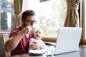 Remote worker sharing time with his newborn baby