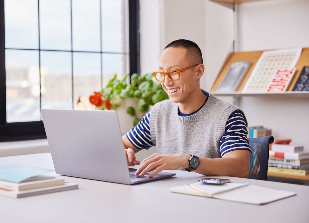Colleague smiling looking at laptop