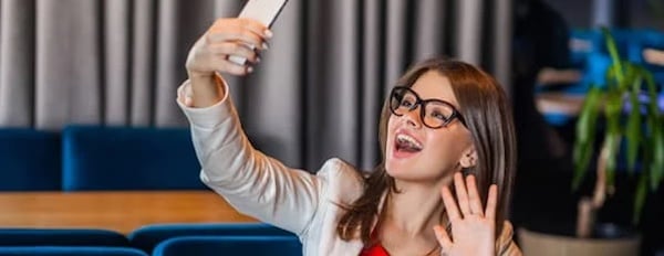 a female creator does a selfie pose as she records a TikTok video